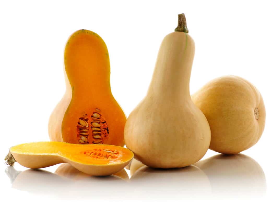 Squashes with one of them sliced into two halves 