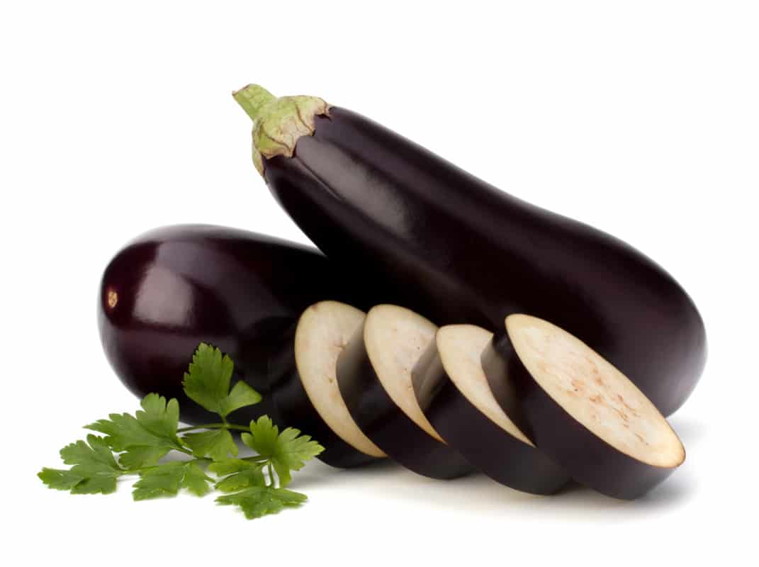 Eggplants with slices and leaves 