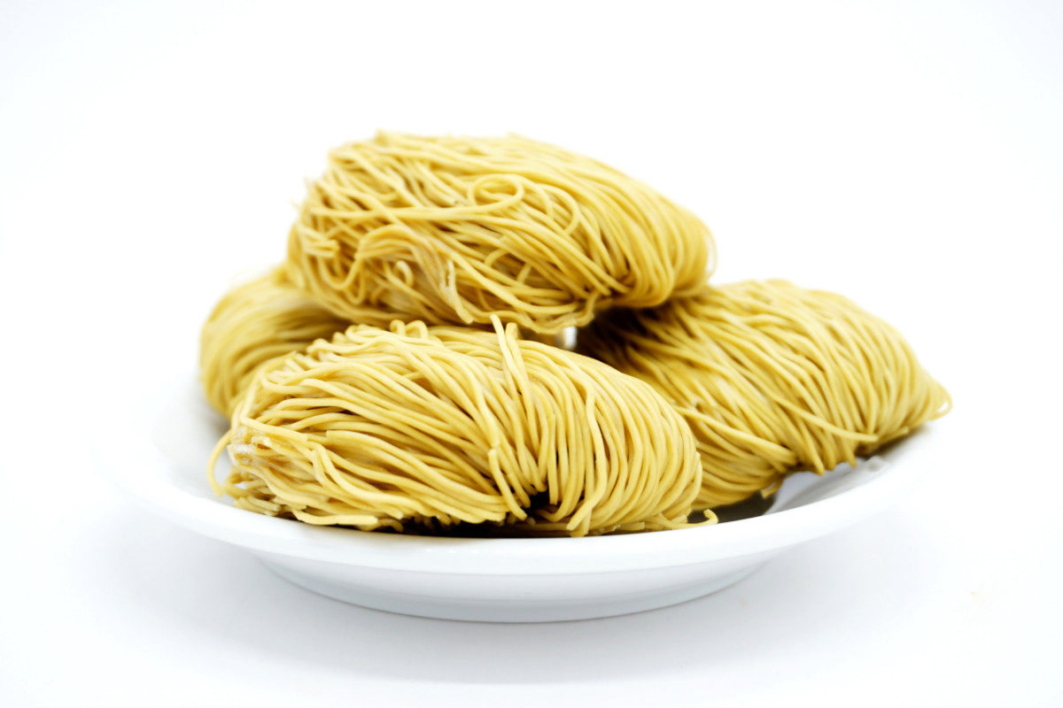 Noodles uncooked stacked on a bowl