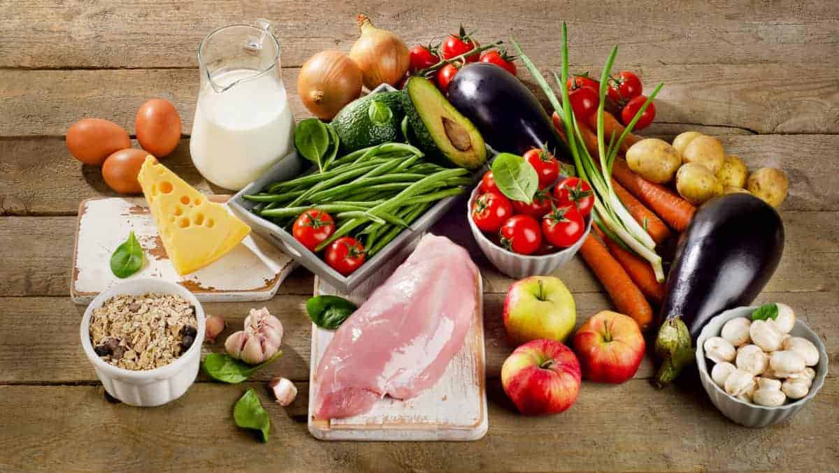 A selection of foods, meats, fruits, vegetables, dairy. 