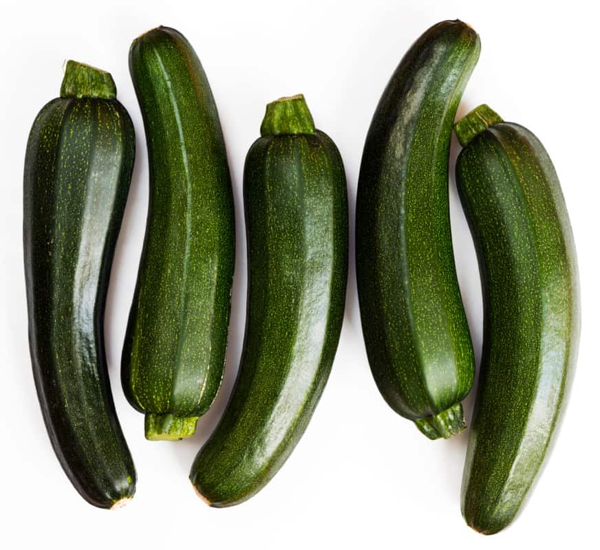 Fresh Zucchinis placed on a flat surface 